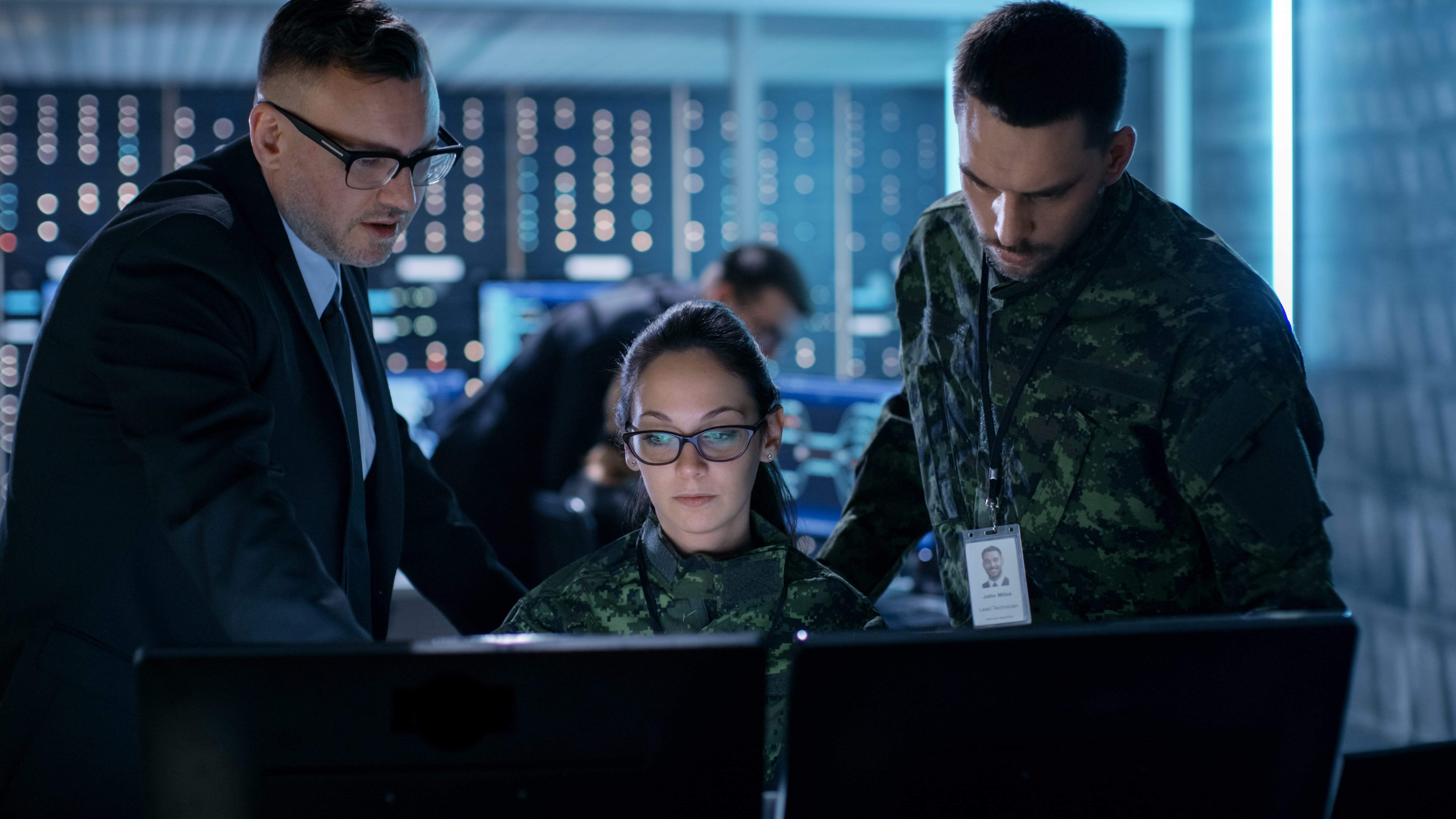 military security experts around a computer